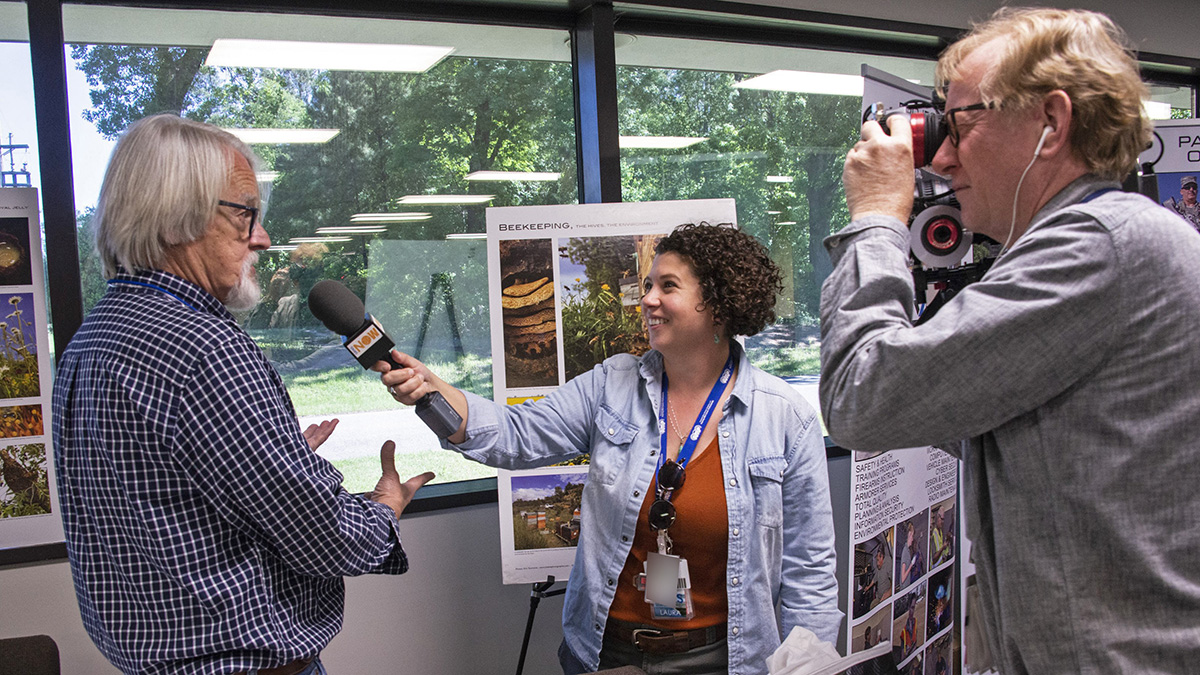 Camera crew interviews an SRS employee.