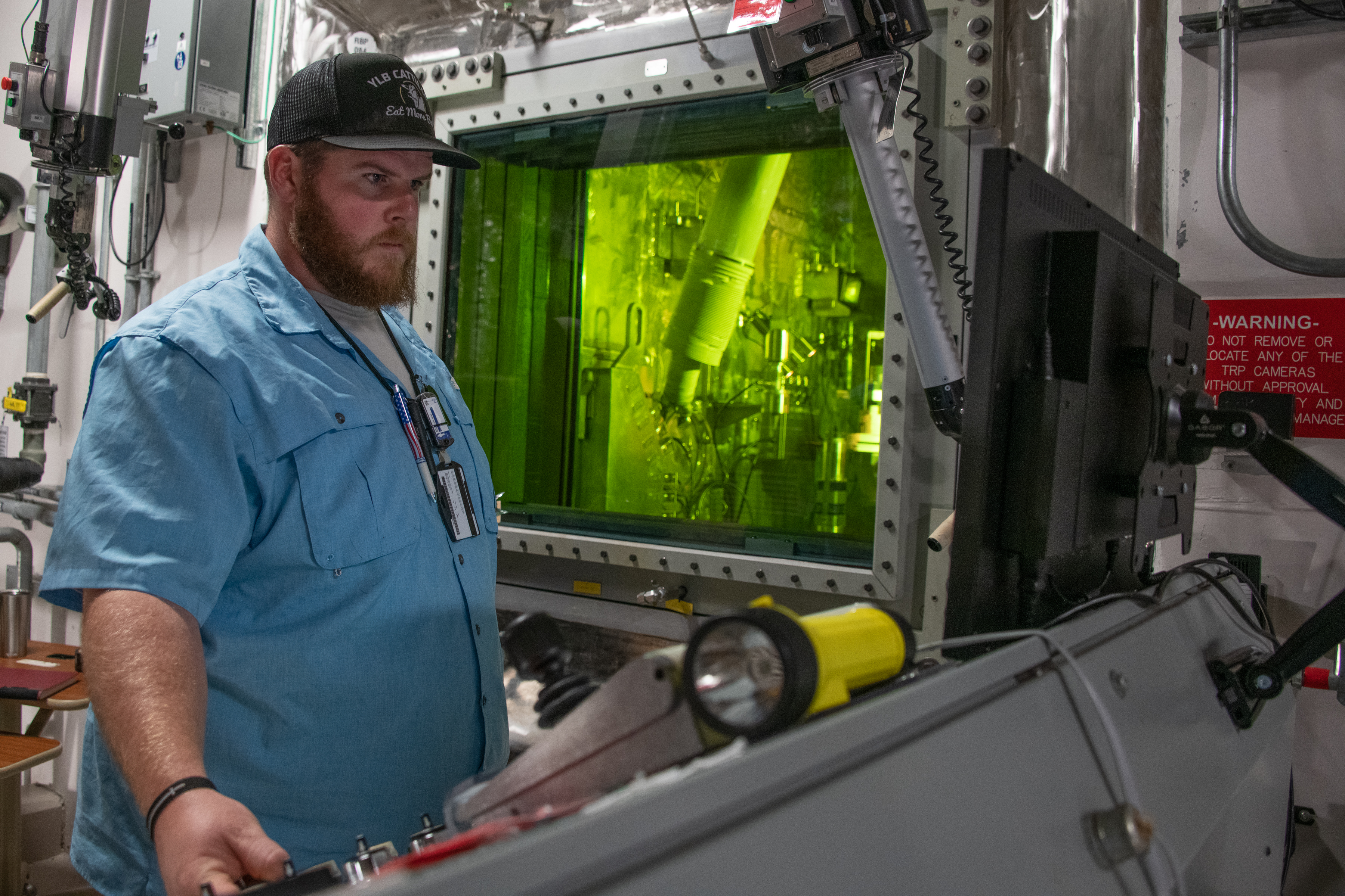 TEF personnel perform irradiated rod cutting in the Target Rod Prep Module.