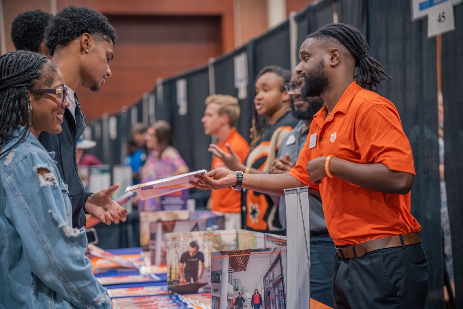 A recruiter from Clemson University connects with local students during College Night.