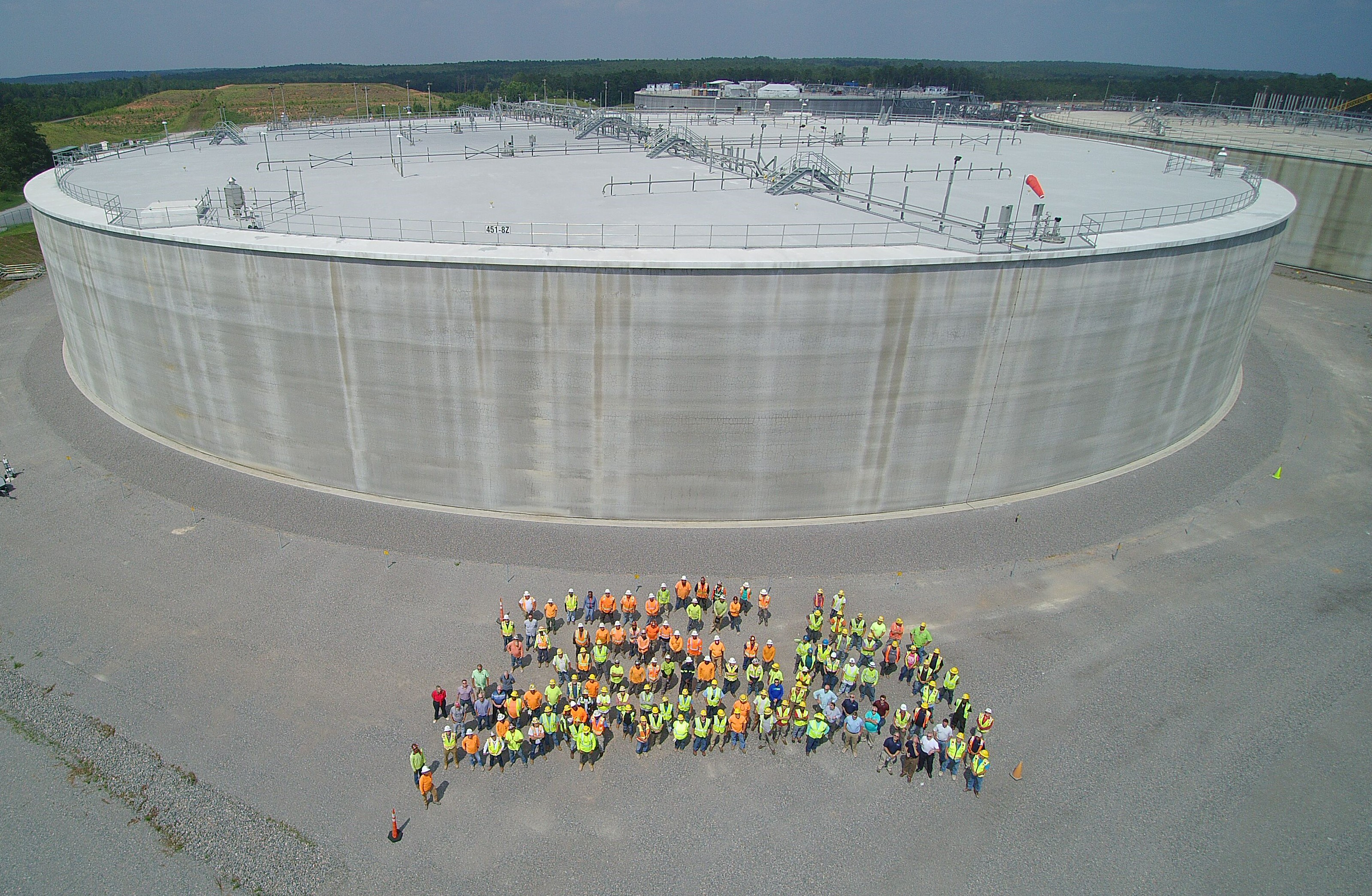 The U.S. Department of Energy-Savannah River and Savannah River Mission Completion team members gather in front of Saltstone Disposal Unit (SDU) 8, the third mega-size unit built at the Savannah River Site. The SDU 8/9 project team won the Project Management Achievement Award from DOE.